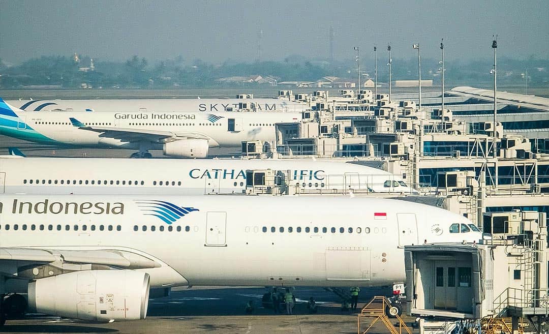 Rows of grounded commercial jetliners parked on the tarmac at Soekarno-Hatta International Airport in Jakarta during flight suspensions caused by volcanic ash.