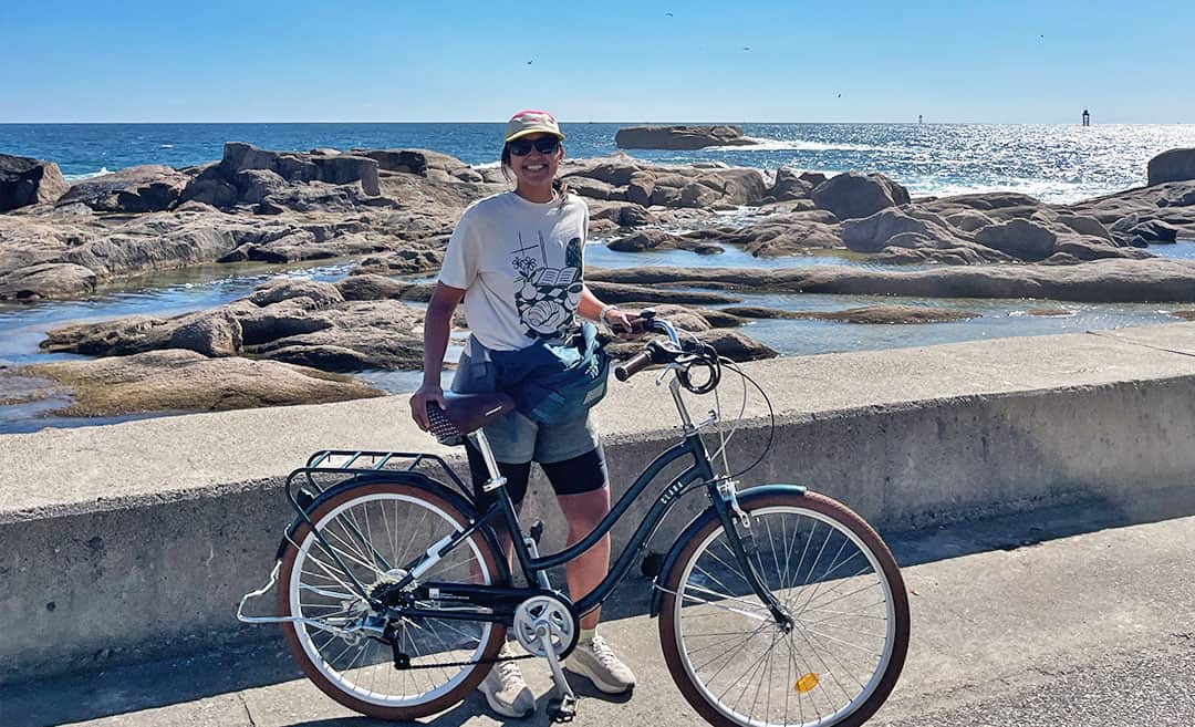 A solo cyclist riding along a scenic coastal road in South Korea toward the North Korean border.